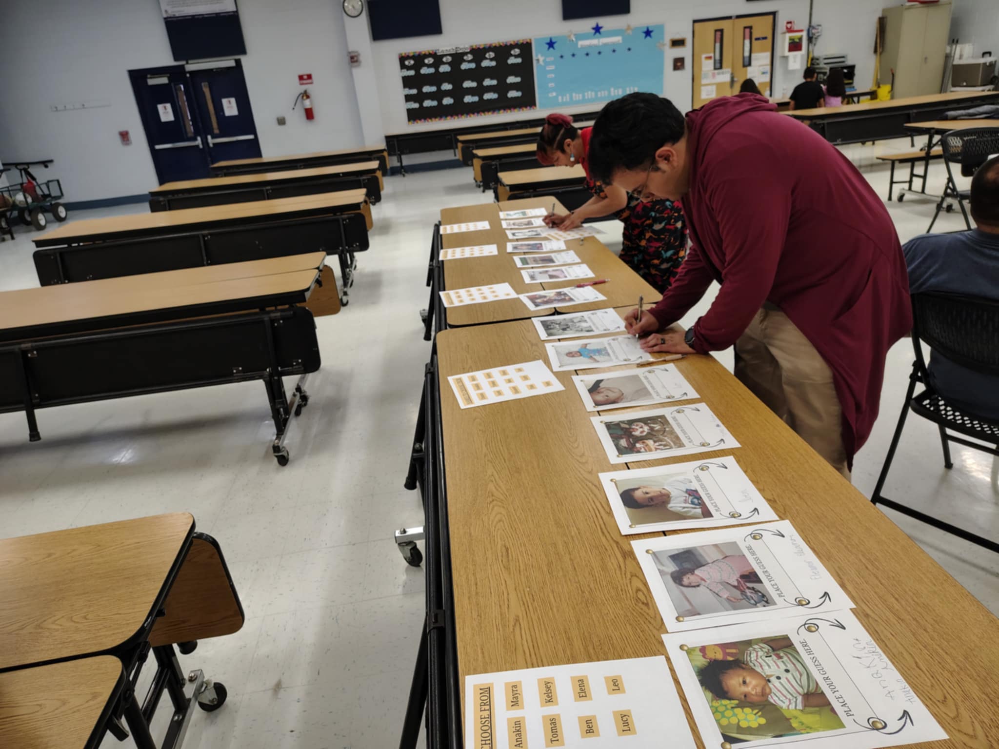 two persons writing on papers